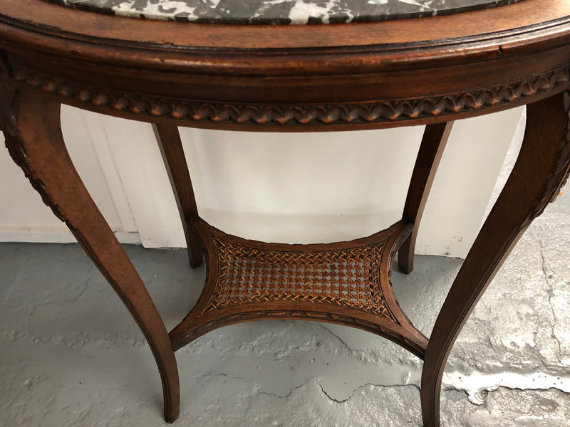 French Fruitwood marble top occasional table. It has two tiers with the bottom being made from cane. In good original condition. Circa 1920's.