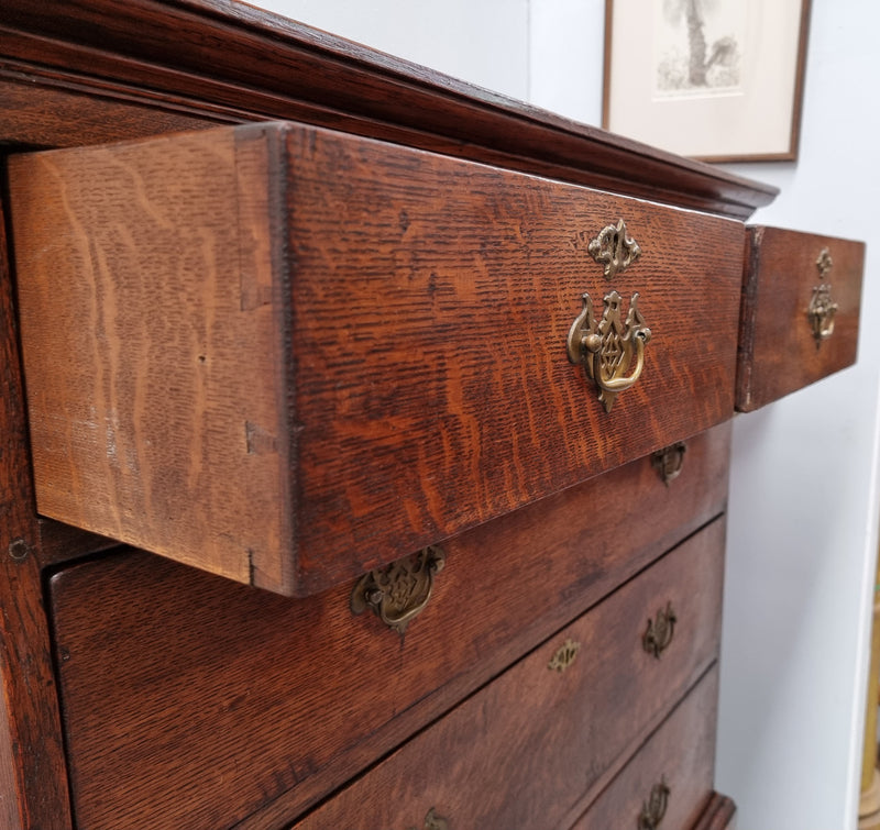 Early 19th Century English Oak chest on stand. It has been sourced in France and has plenty of storage space with eight drawers. In good original detailed condition.