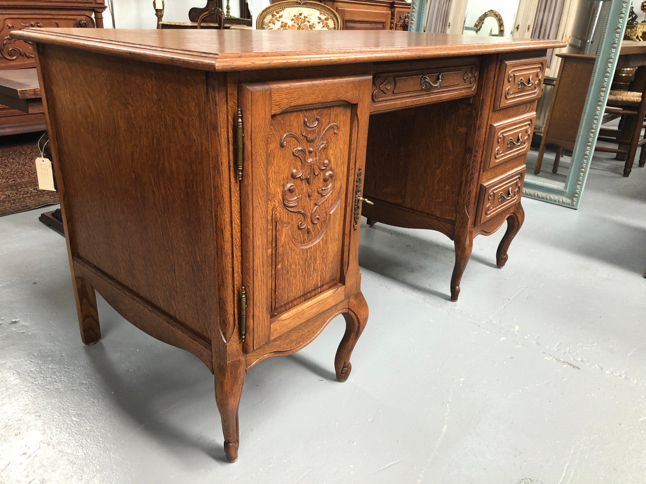 Beautifully carved French oak small desk with three drawers and a cupboard for all your storage needs. In good original condition. Great size for small spaces.