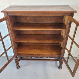 Tudor oak 2 door astral glaze and beveled glass bookcase.  Good original condition. Circa 1930s.