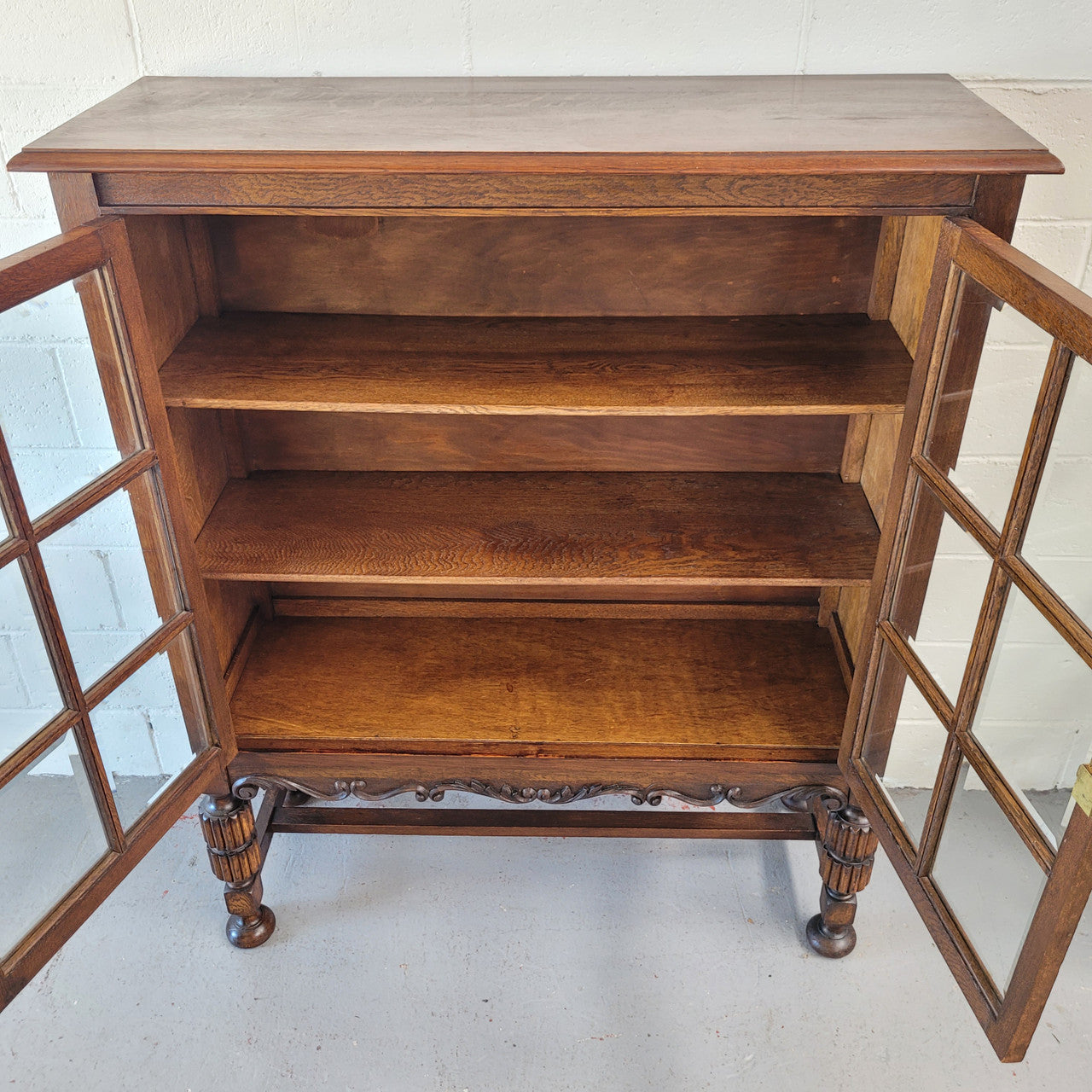Tudor oak 2 door astral glaze and beveled glass bookcase.  Good original condition. Circa 1930s.