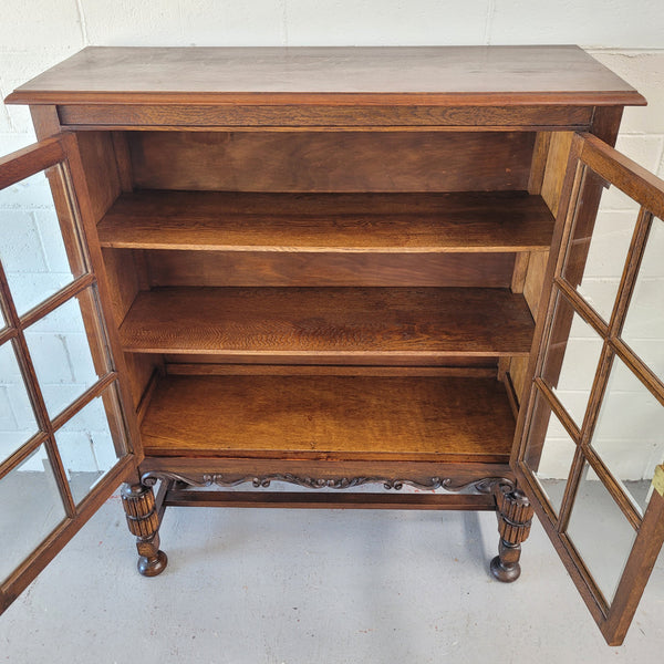 Tudor oak 2 door astral glaze and beveled glass bookcase.  Good original condition. Circa 1930s.