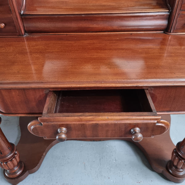 Victorian Mahogany duchess dressing table with tilt mirror on scrolled supports. It has seven trinket drawers and lift up storage. It is in good original condition and has been sourced locally.