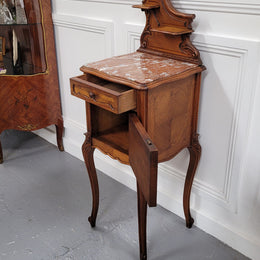 French Louis XV style Walnut single bedside cupboard with inset marble top. It has been sourced from France and is in good original detailed condition.