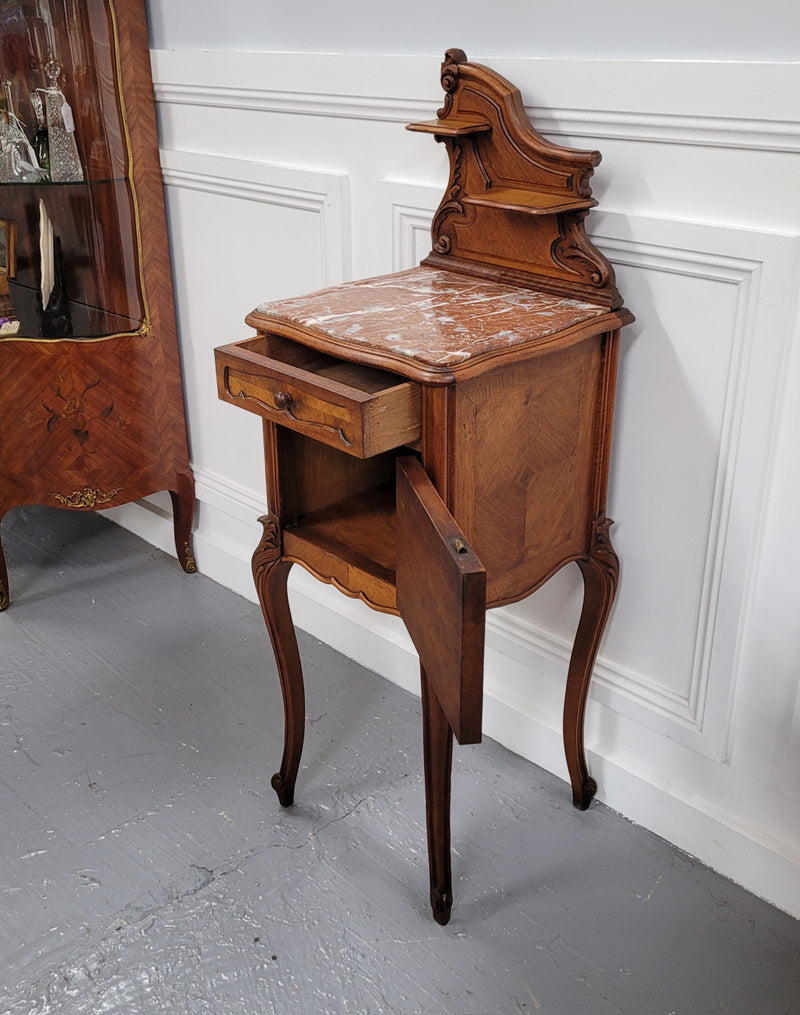 French Louis XV style Walnut single bedside cupboard with inset marble top. It has been sourced from France and is in good original detailed condition.