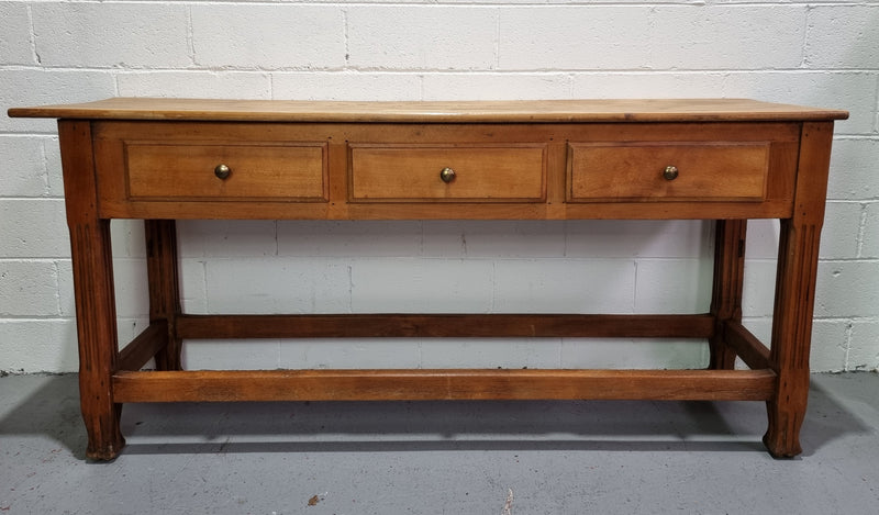 Late 19th Century Cherrywood console table with three drawers. In good used, detailed rustic condition.