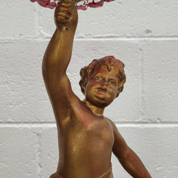 Late Victorian spelter table centerpiece/comfort featuring putti holding ruby glass bowl. In good original condition with no damage to the glass.