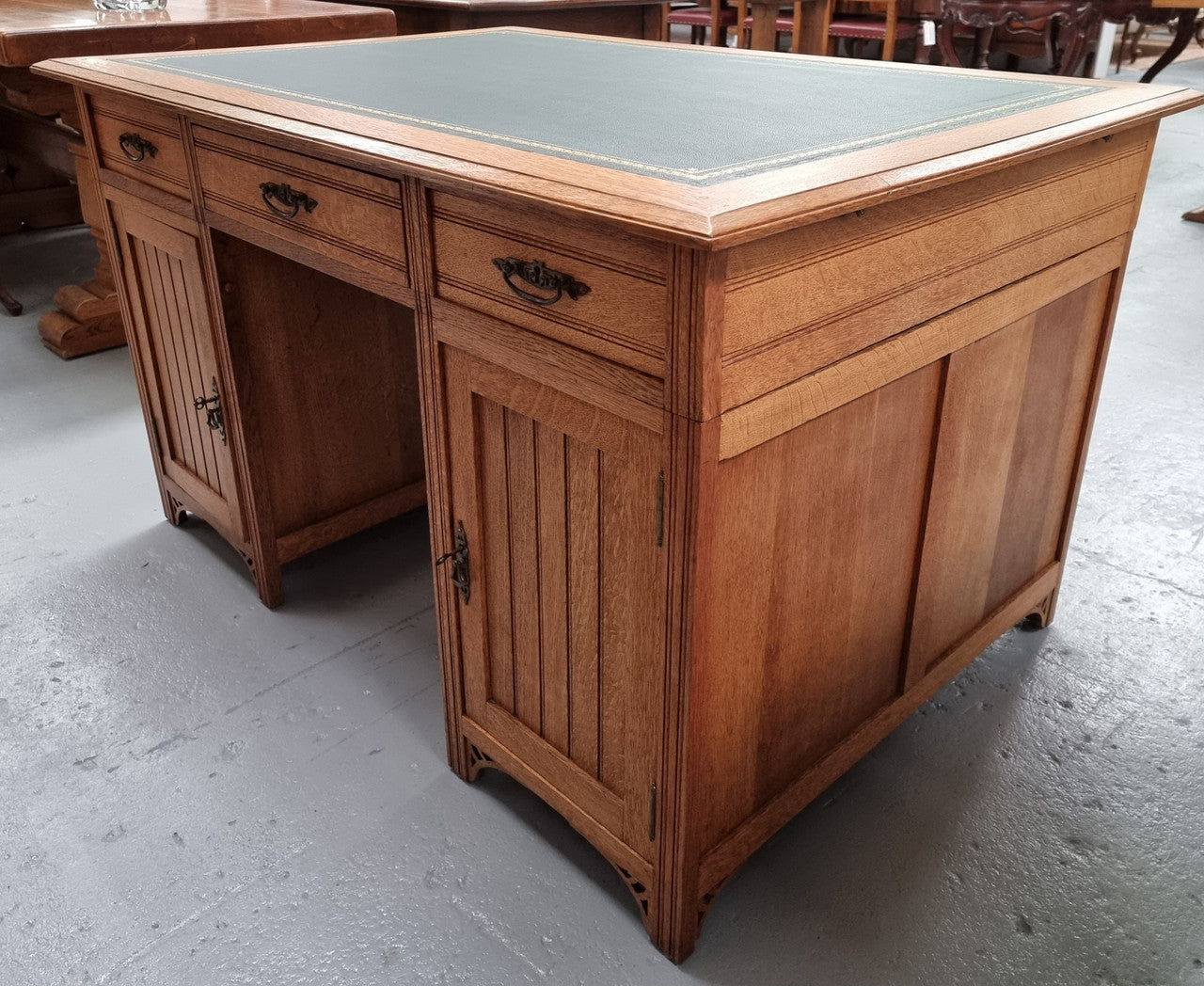 French Oak Art Deco full partners desk with leather top. Plenty of storage with both sides having three drawers at the top and two cupboards on both sides, one side has a filing section with three internal drawers and the other has a shelf on one side with three internal drawers as well. In good original detailed condition.