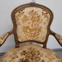 Beautiful pair of French Walnut late 19th Century Louis XV style upholstered arm chairs with original paint. These chairs have extra wide seats and are very comfortable and in good original condition. The upholstery is in good used condition meaning it can be used as is or reupholstered for a different look.