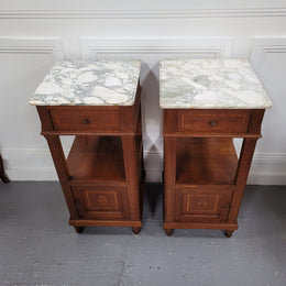 Pair of Antique French Oak Louis XVI style marble top bedside cabinets. They have decorative inlay and have been sourced from France. They are in good original detailed condition.