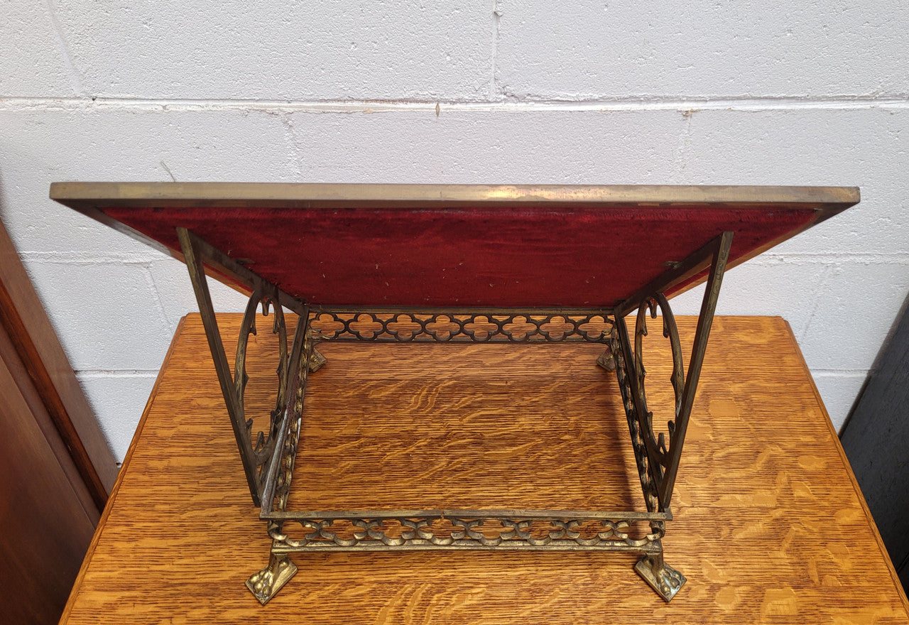 Antique French brass Gothic Revival book stand with red velvet. It has sourced from France and is in good original condition.