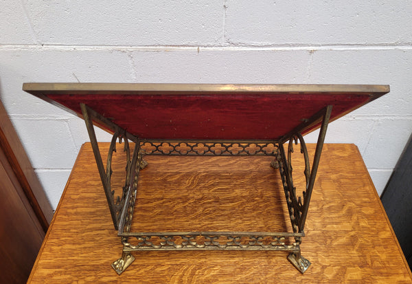 Antique French brass Gothic Revival book stand with red velvet. It has sourced from France and is in good original condition.