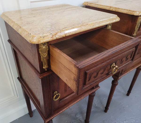 French Oak pair of Louis 16th style marble top bedsides with stunning bronze mounts. They have been sourced from France and are in good original detailed condition.