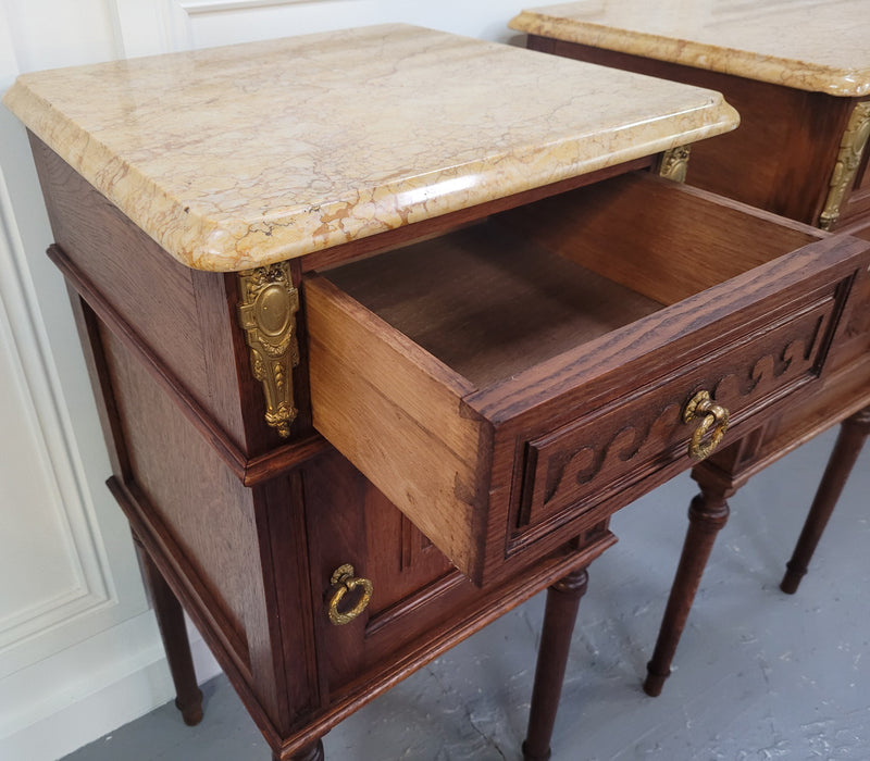 French Oak pair of Louis 16th style marble top bedsides with stunning bronze mounts. They have been sourced from France and are in good original detailed condition.