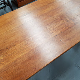 French Oak Spanish style dinner table with beautiful simple iron work underneath. Table top is in good original condition with character marks and has a wax finish. Circa 1930.