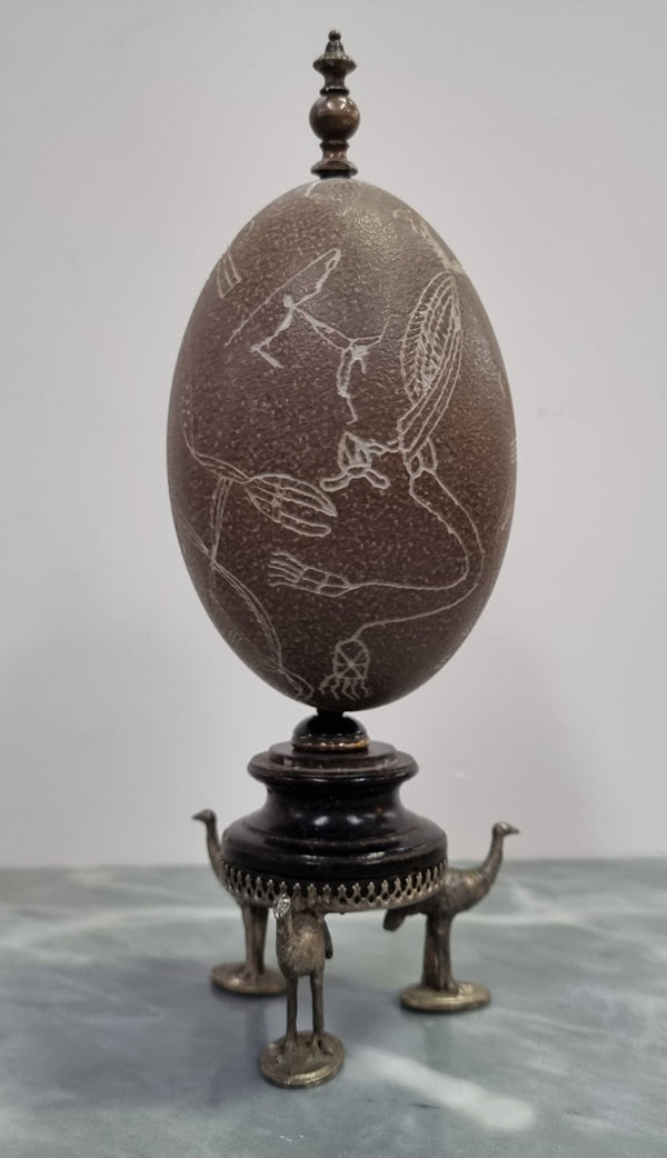 Superbly carved Emu egg on a emu metal and ebony base. It depicts an Aboriginal hunting scene and dreaming's. It is in good original condition, please view photos as they help form part of the description.