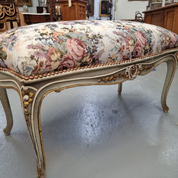 Antique painted Louis XV style upholstered stool. It has lovely floral upholstery that is in good condition with no tears. It is in good original detailed condition.