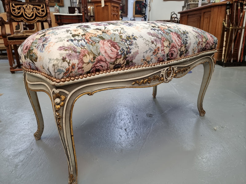 Antique painted Louis XV style upholstered stool. It has lovely floral upholstery that is in good condition with no tears. It is in good original detailed condition.