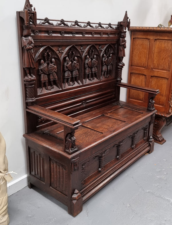 Early 19th Century French Oak Gothic style hall seat with a lift up seat. It has amazing detailed carvings and is in good original detailed condition.