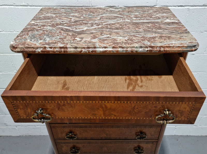 Louis XV style parquetry inlaid marble top semainier. It has seven drawers and a stunning coloured marble top. In good original condition.
