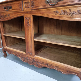 Stunning 19th Century French Walnut Buffet à Glissant from Provence, France. This is an exceptional charming piece and very functional with plenty of storage space, two large cupboards at the bottom, two drawers in the middle and two sliding doors either side at the top and finished off with a small central cupboard. In good original detailed condition.