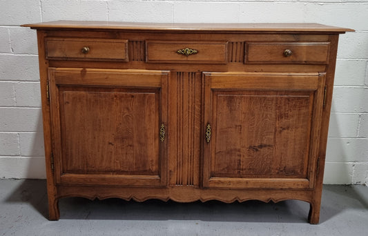 French Oak Early 19th Century sideboard with two doors and three drawers. In good original condition.