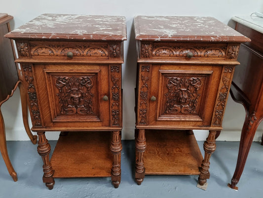 Late 19th Century pair of beautifully carved gothic style French oak bedside cabinets. It has lovely coloured marble tops with a drawer and cupboard for storage. In good original detailed condition.