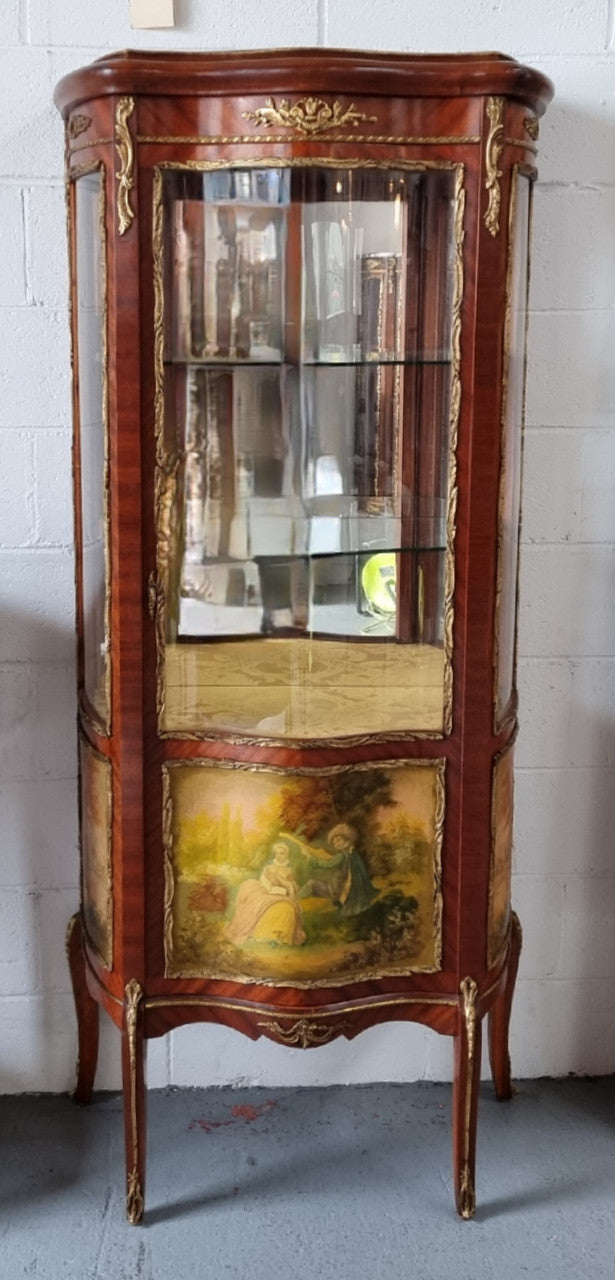 Lovely Vintage French Louis XVth style Vitrine. It has lovely gilt mount details and two glass shelves with room also for storage in good original condition.