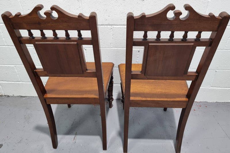Pair of Edwardian Mahogany hall chairs with original tile in back. They are in very good original detailed condition.