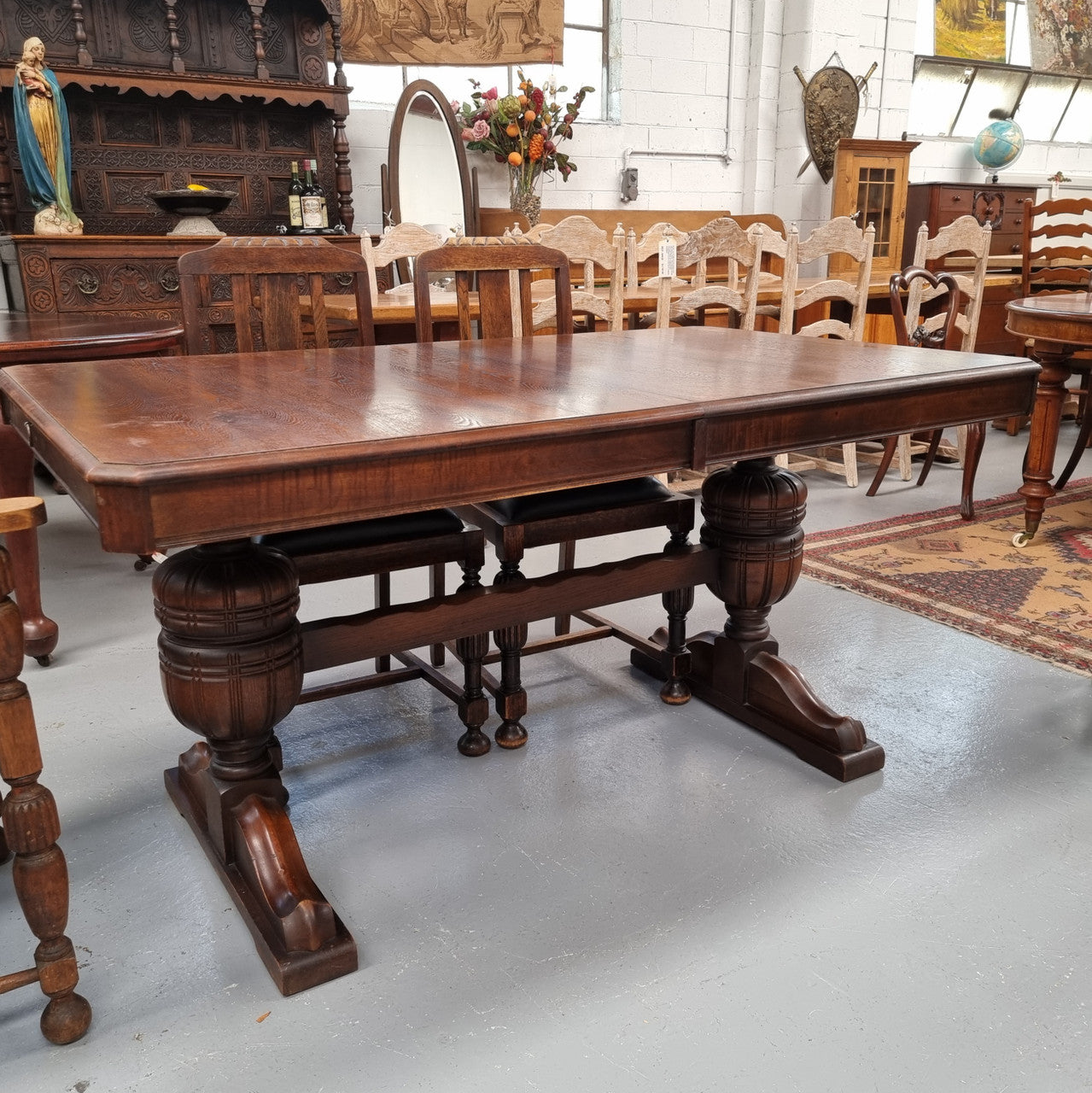 Tudor oak dining setting consisting of draw leaf extension table, 4 dining chairs and 2 carver chairs. Upholstery in excellent condition. Circa: 1930’s. The table, chair and carver chairs are in good original detailed condition.