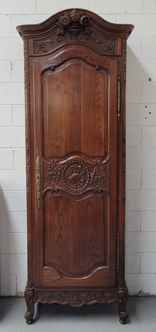 French Oak "Bonnetiere" cupboard of pleasing small proportions. It has four adjustable shelves and plenty of storage space