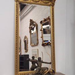 Impressive French Napoleon III water gilded mantle mirror. It is beautifully decorated with allegorical themes and has been sourced from France. In good original detailed condition with original mirror.