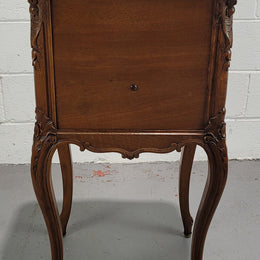 Beautiful French Walnut carved bedside cabinet with a lovely grey coloured inset marble top. The inside of the cupboard is also marble lined and it is in good original detailed condition.
