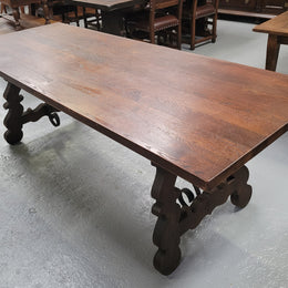 Spanish style French Oak farmhouse table with ironwork underneath. It is in good original detailed condition and has been sourced from France.