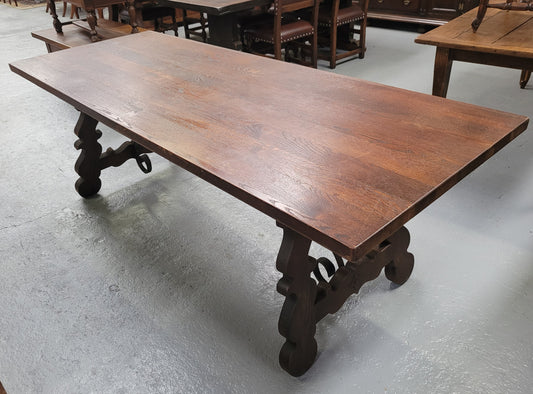 Spanish style French Oak farmhouse table with ironwork underneath. It is in good original detailed condition and has been sourced from France.