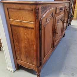 Lovely French Oak three-door sideboard with beautifully carved details and there is also a drawer. In good original detailed condition.