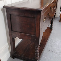 Rare size 19th Century English oak dresser base. It has two good size drawers and amazing patina. It has been sourced from France and in good original detailed condition.
