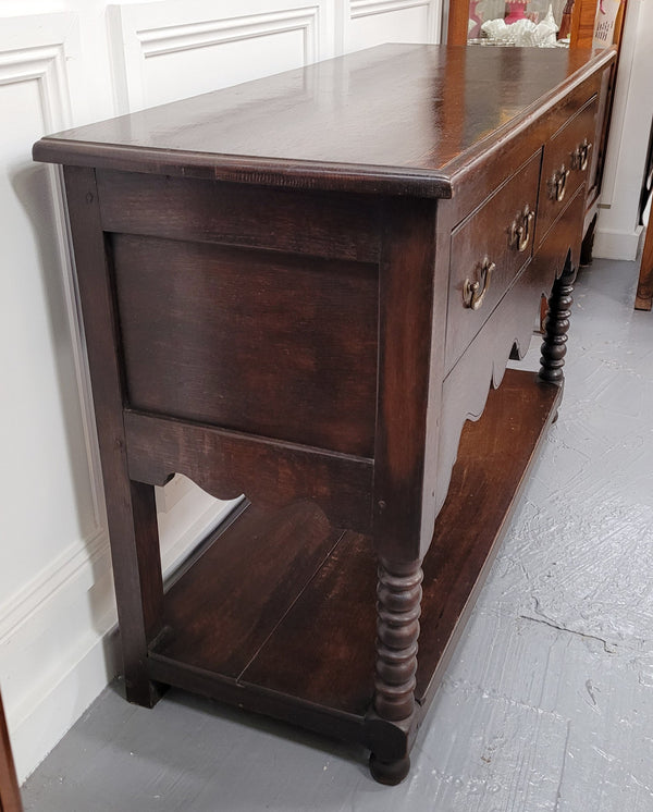 Rare size 19th Century English oak dresser base. It has two good size drawers and amazing patina. It has been sourced from France and in good original detailed condition.