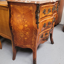 Antique French Louis XV style compact three drawer marble top commode with marquetry inlay and ormolu mounts. Sourced from France and in good original detailed condition.
