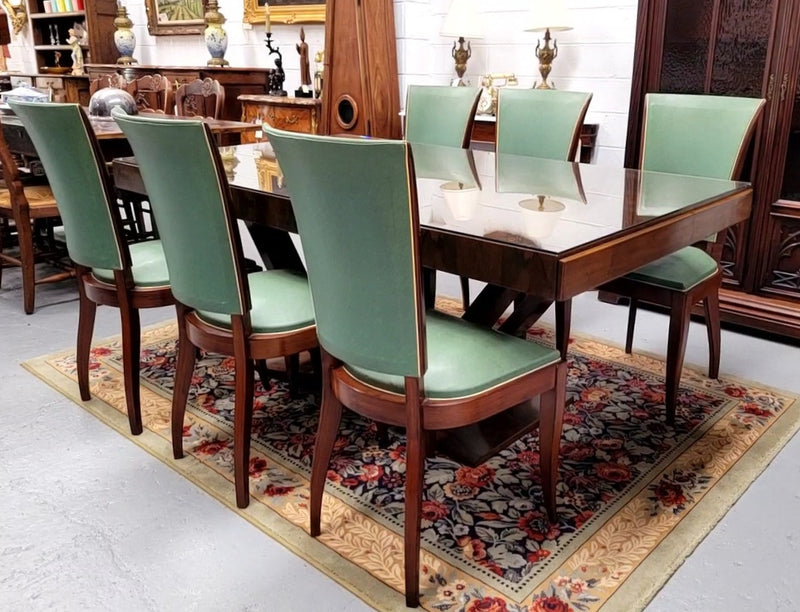 French Art Deco Figured Walnut dining table and six chairs. This stylish table also comes with a glass top and can be used with or without it. The chairs are very comfortable and the table can also fit another two chairs at either end making it a 6-8 seater. The table is in good original detailed condition with character marks to the top of table as shown in the pictures. This table and six chairs have been sourced locally.