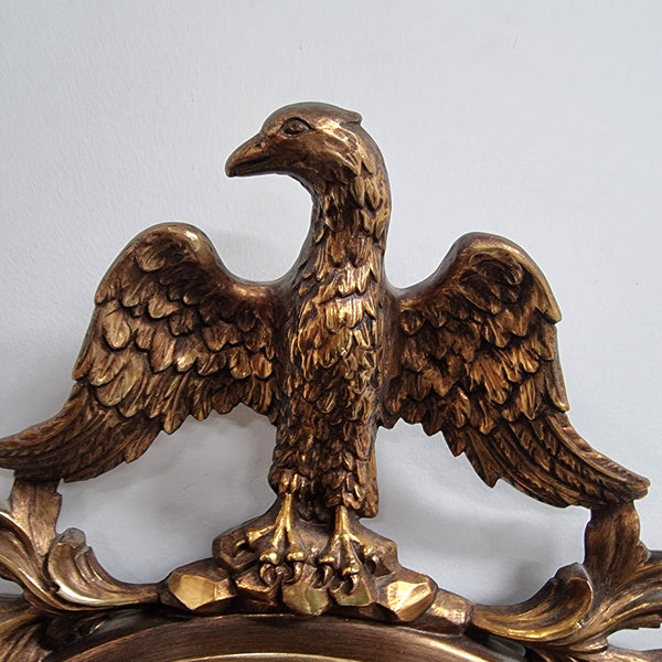 Vintage gilt framed convex mirror featuring carved eagle. It has been sourced from France and is in good original condition, please view photos as they help form part of the description.