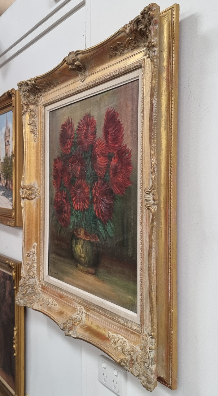 Charming oil on canvas of red Chrysanthemums painting. Sourced in France and signed in a lovely ornate gilt frame. In good original detailed condition.