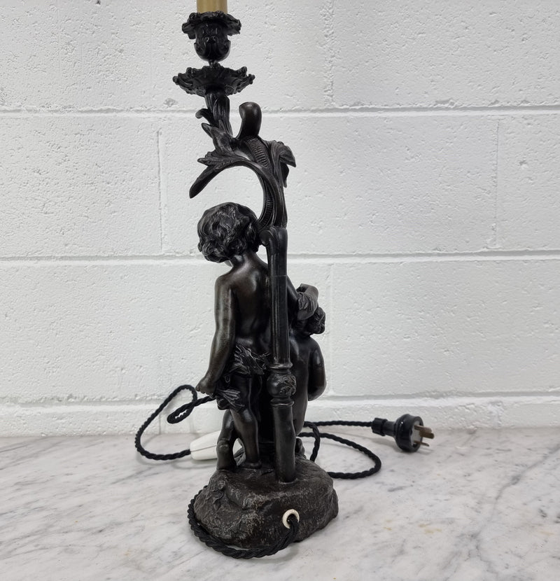 Antique French bronzed metal lamp with cherub's. in very good working original detailed condition.