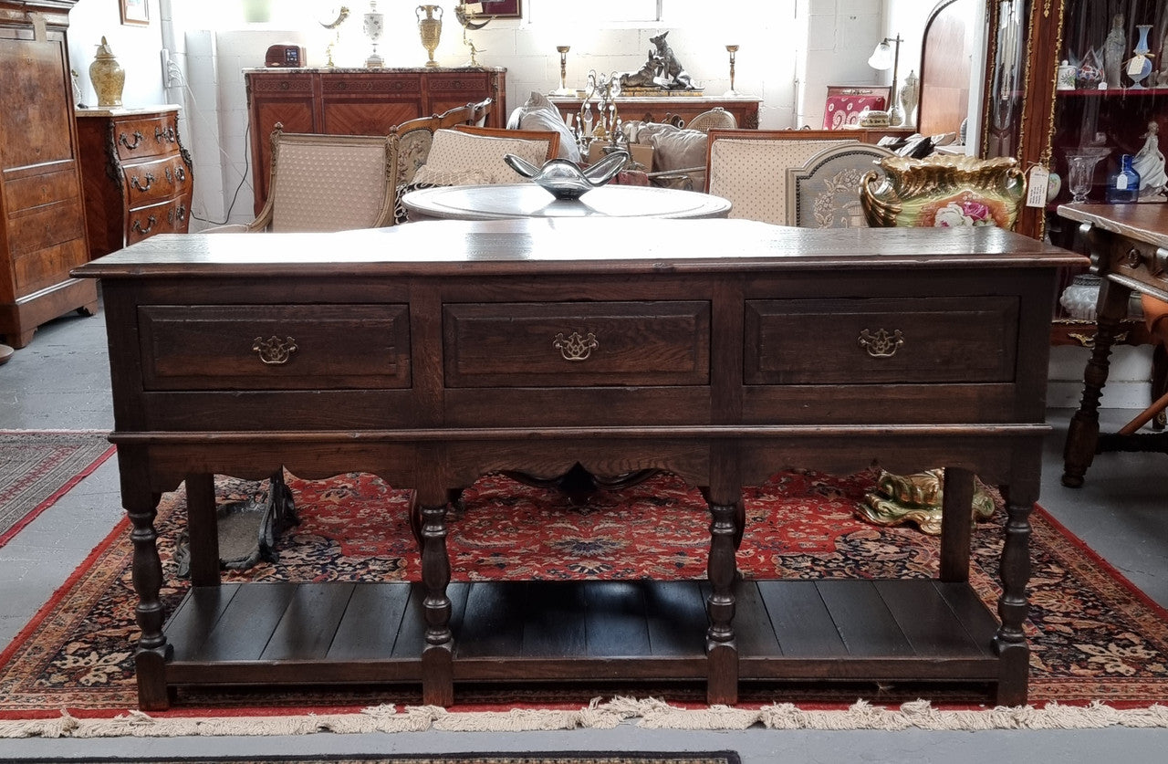 A very hard to find Vintage English kitchen dresser base of narrow proportions, sourced from France. In good original detailed condition.