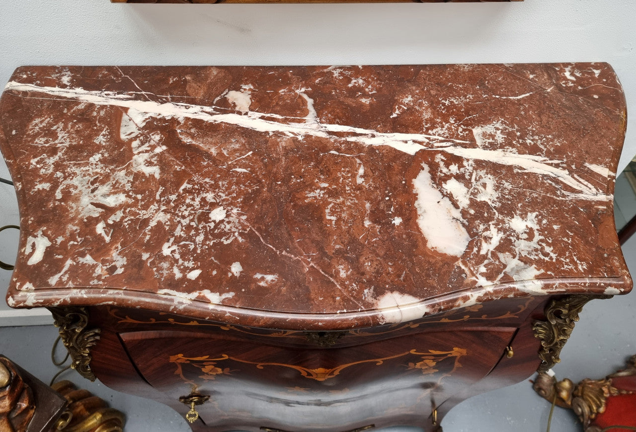 Stunning French Transitional style Mahogany marquetry inlay salon cabinet in the bombe shape. It has one draw, one shelf, marble top & ormolu decoration. Sourced from France and in good original detailed condition.