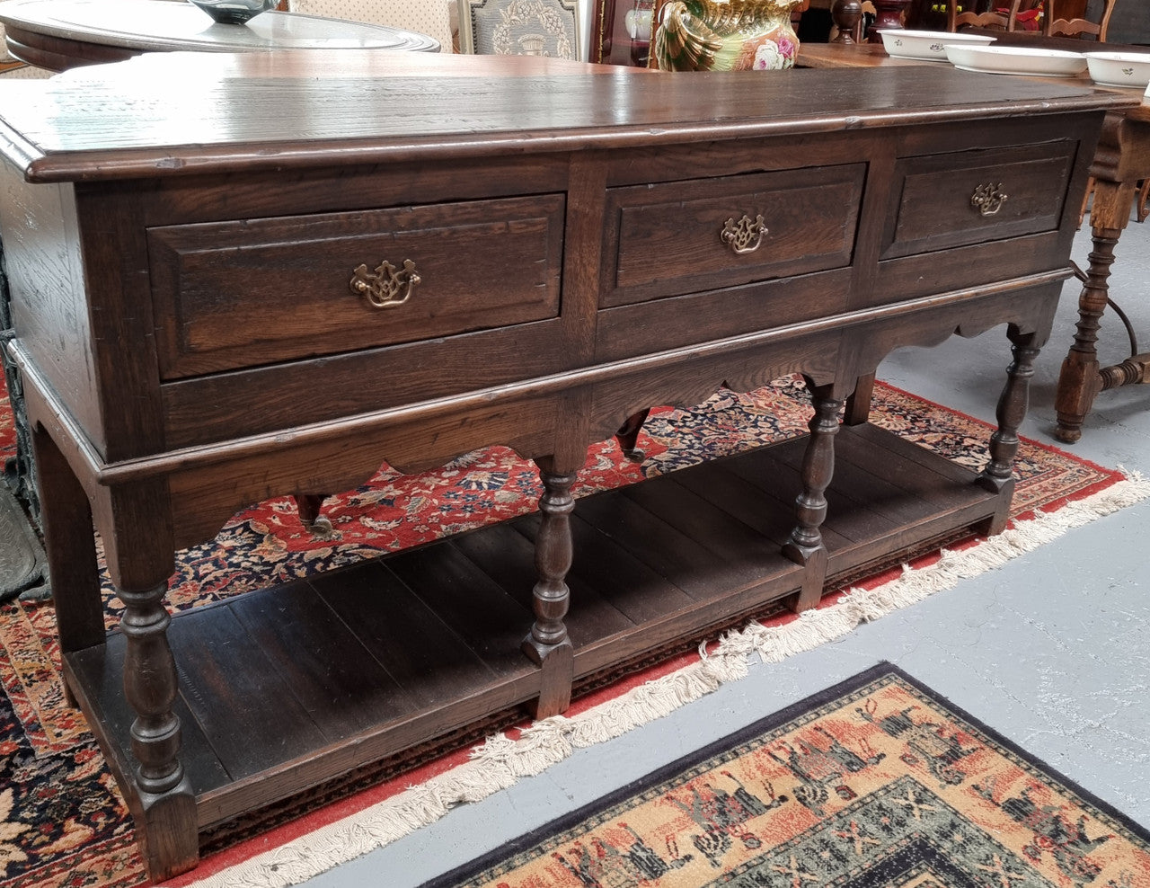 A very hard to find Vintage English kitchen dresser base of narrow proportions, sourced from France. In good original detailed condition.