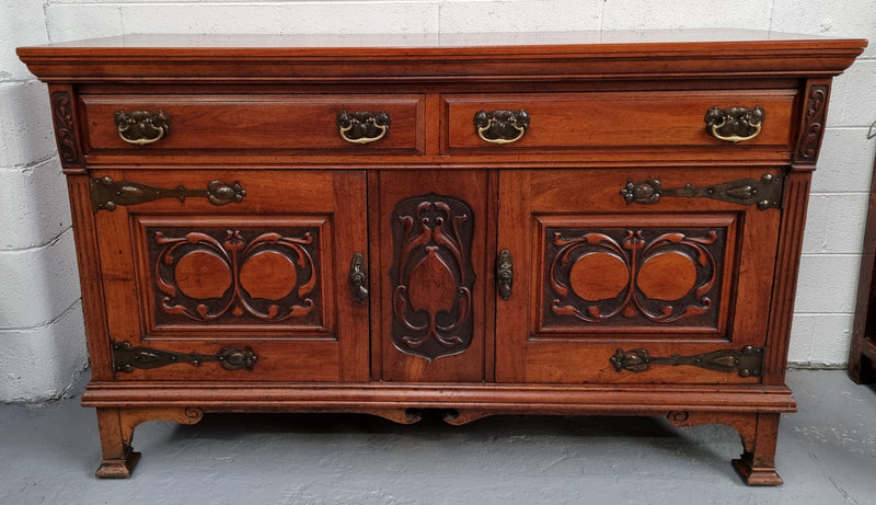 Beautiful decorative Art Nouveau sideboard with lovely handles and beautiful carved detailing. It is in good original detailed condition.