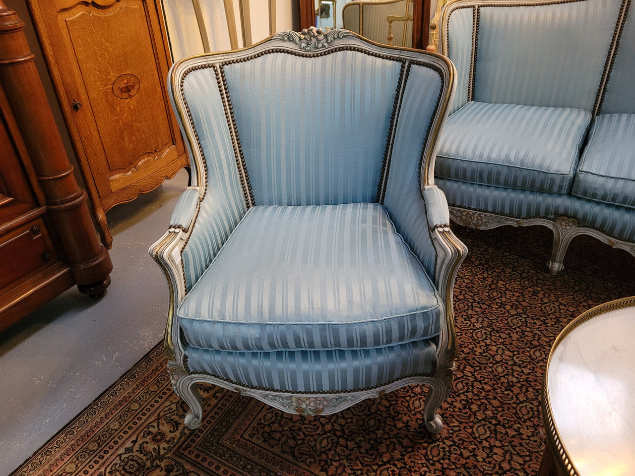Well Proportioned Louis XV Salon Suite consisting of well proportioned 3 seater down cushioned, winged settee with 2 matching bergere chairs. All upholstered in stunning blue self stripe fabric. In excellent condition. Circa: 1930's.