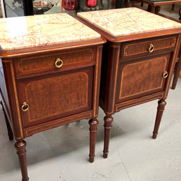 A lovely French inlaid pair of flame mahogany bedside cabinets with ormolu and in good condition.