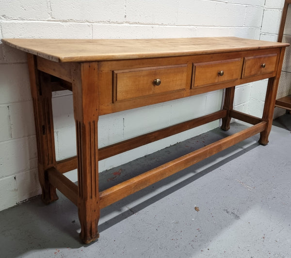 Late 19th Century Cherrywood console table with three drawers. In good used, detailed rustic condition.